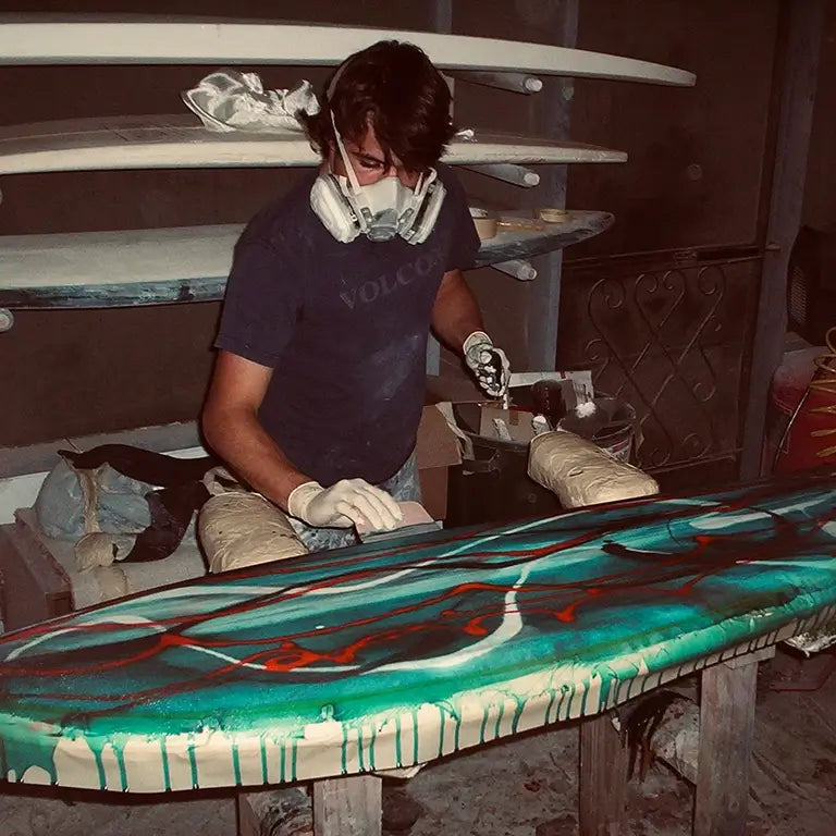 DJ Kane shaping glass on a porch in Florida DK Surfboards About Us Story